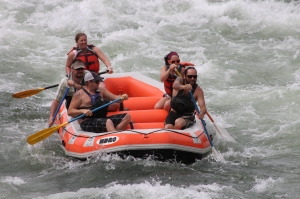 A guide in training gets her turn in the hot seat as she commands her crew through this section of whitewater.